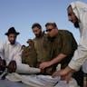 Reading the Torah during the Second Lebanon War. (Denis Sinyakov/AFP via Getty Images) Reading the Torah during the Second Lebanon War. (Denis Sinyakov/AFP via Getty Images)