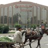 A boy sells greens in front of the British chain store Sainsbury's in Cairo, April 2000. (Marwan Naamani/AFP via Getty Images) A boy sells greens in front of the British chain store Sainsbury's in Cairo, April 2000. (Marwan Naamani/AFP via Getty Images)