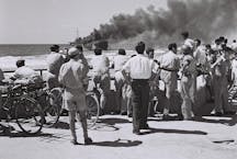 Watching the Altalena burn. (Israel Government Press Office via Wikimedia.)