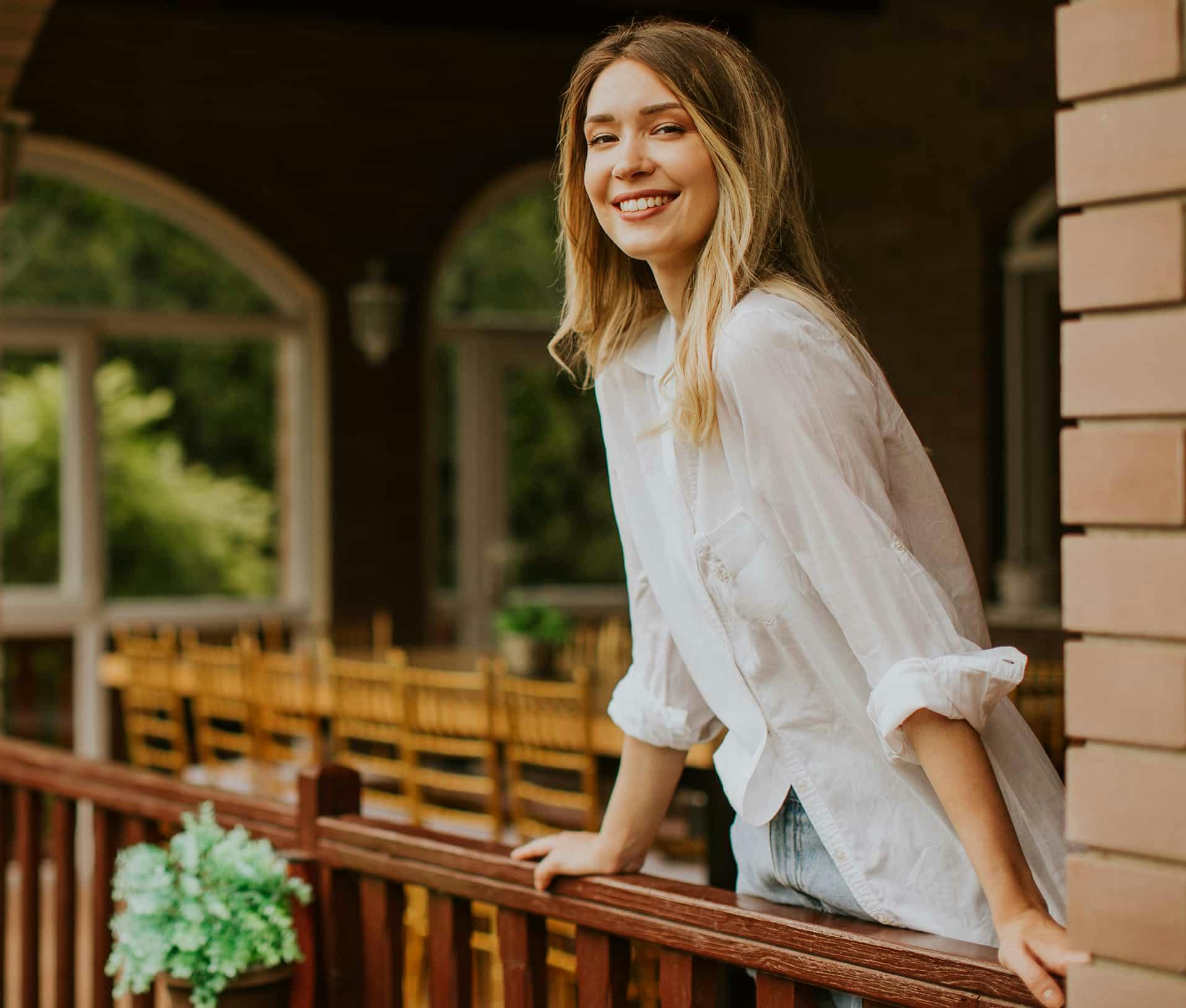 Woman on balcony smiling