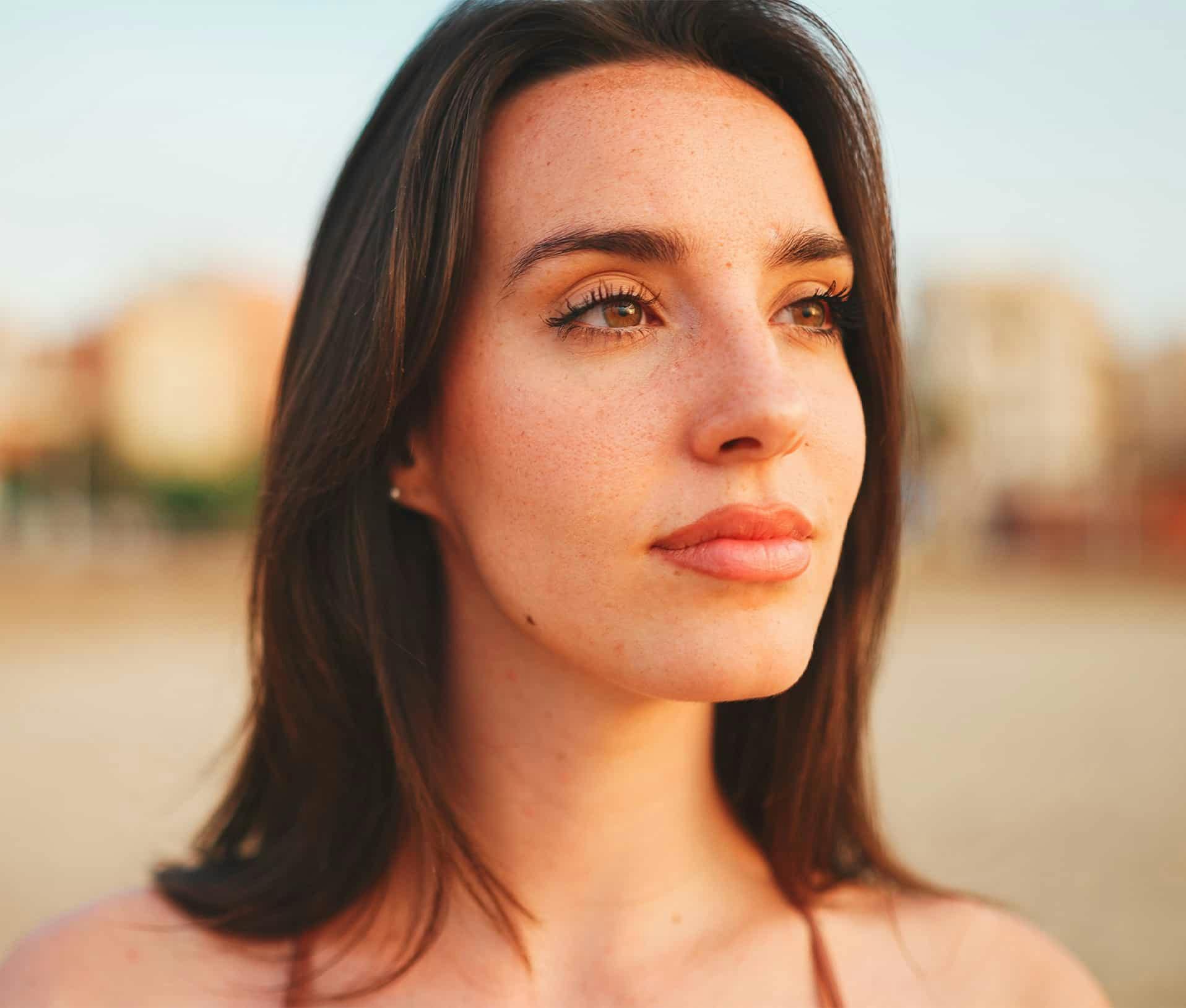 Woman outside looking off into the distance