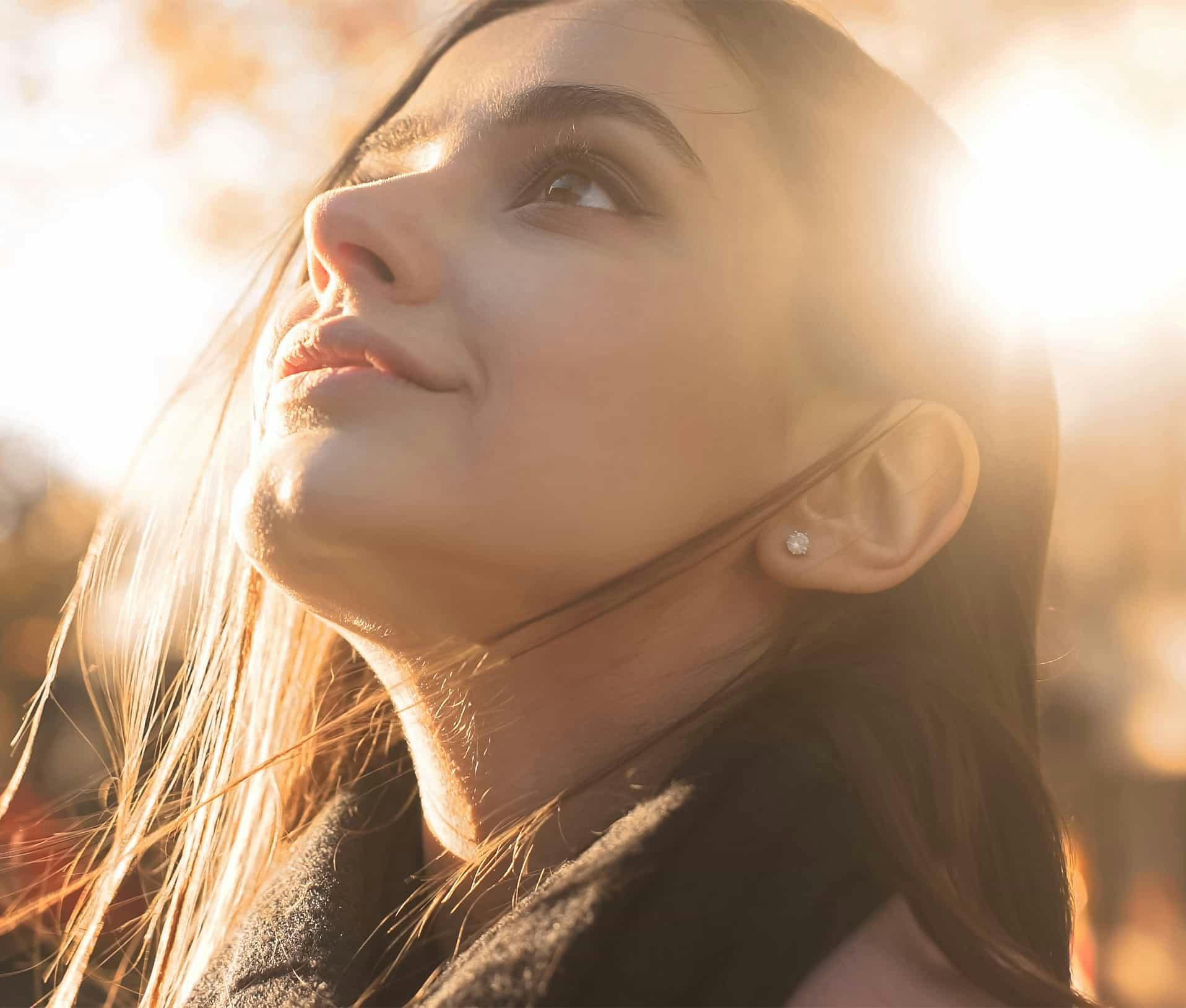 Woman ooutside looking up at sky