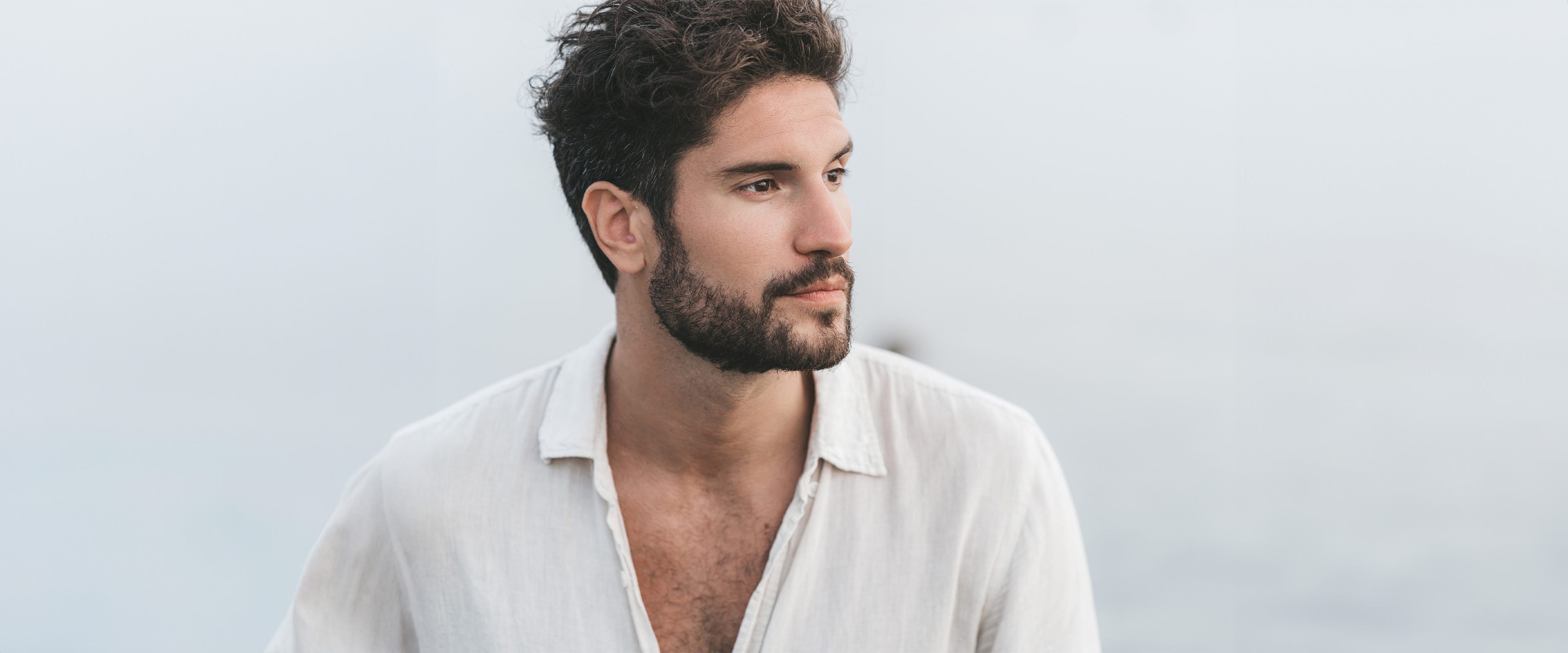 A man outside in loose fitting shirt