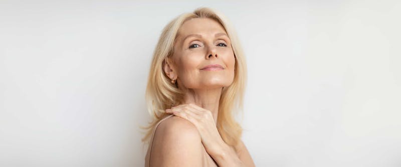 mature woman looking at camera with chin tilted up