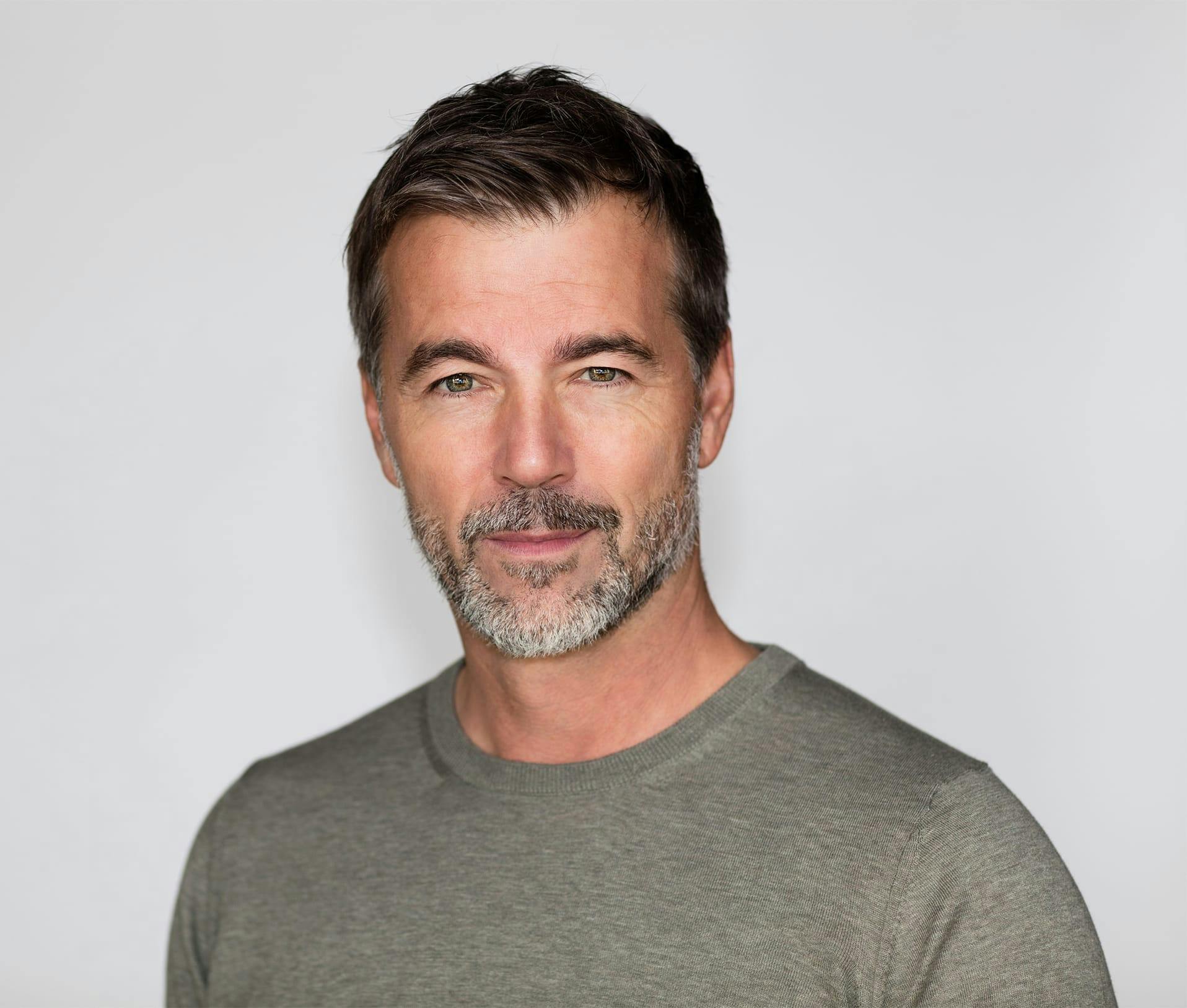 Man with grey beard and dark hair