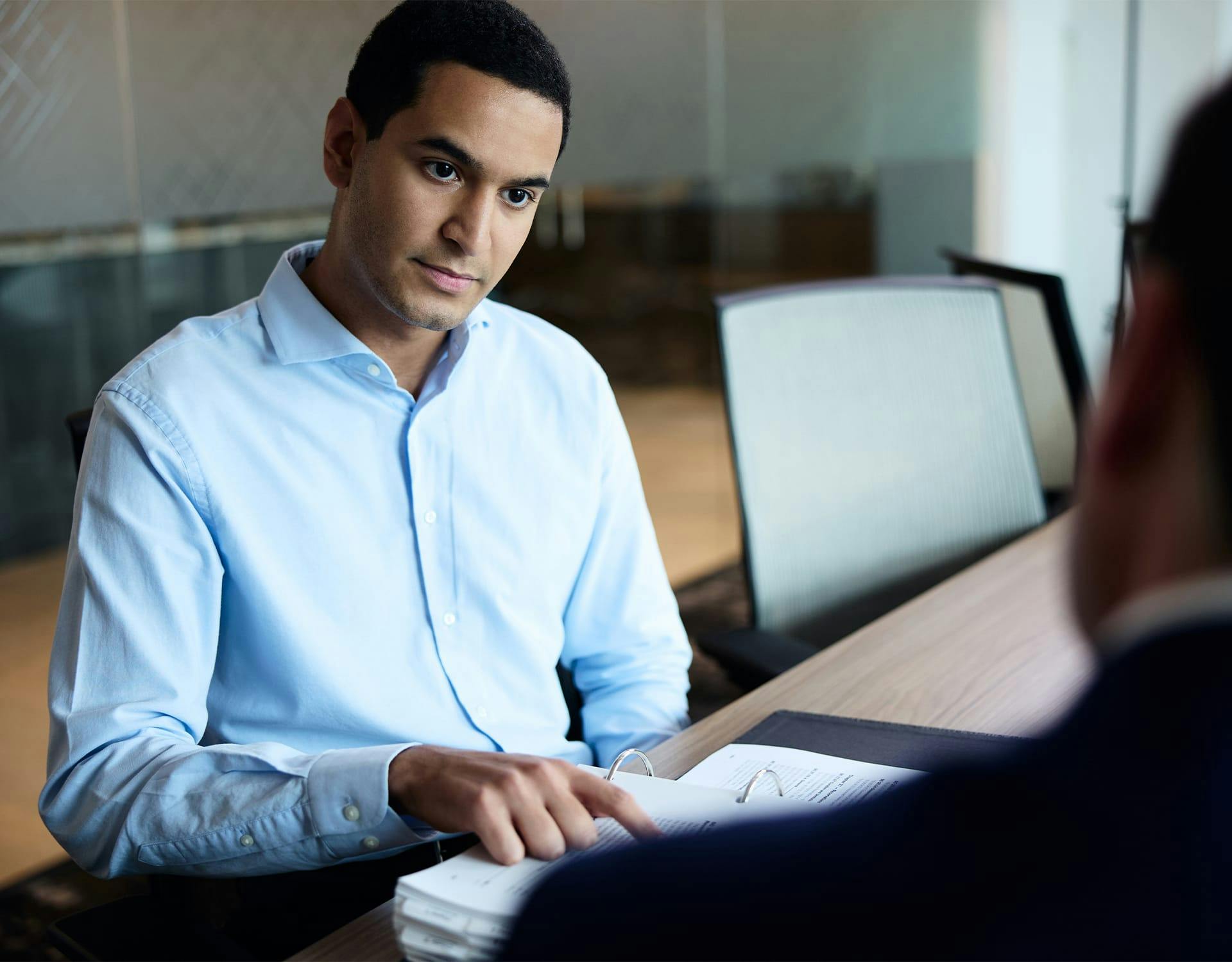 man pointing to a folder