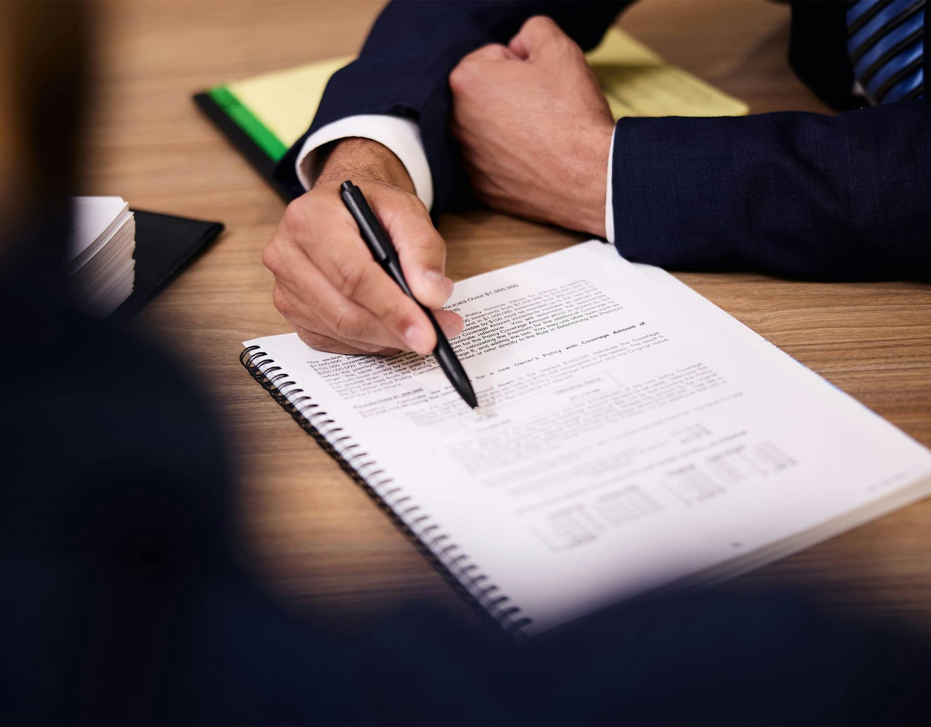 man pointing to documents with pen