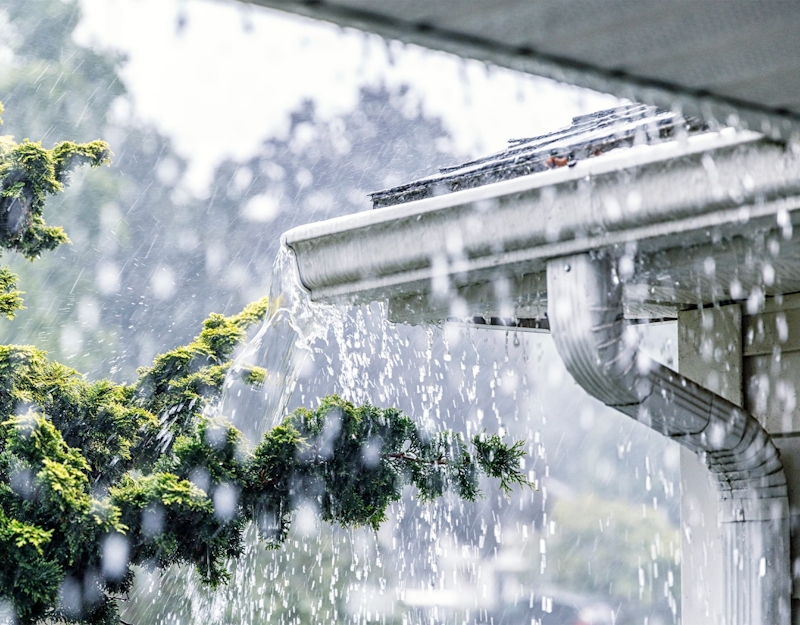 heavy rain falling off a roof