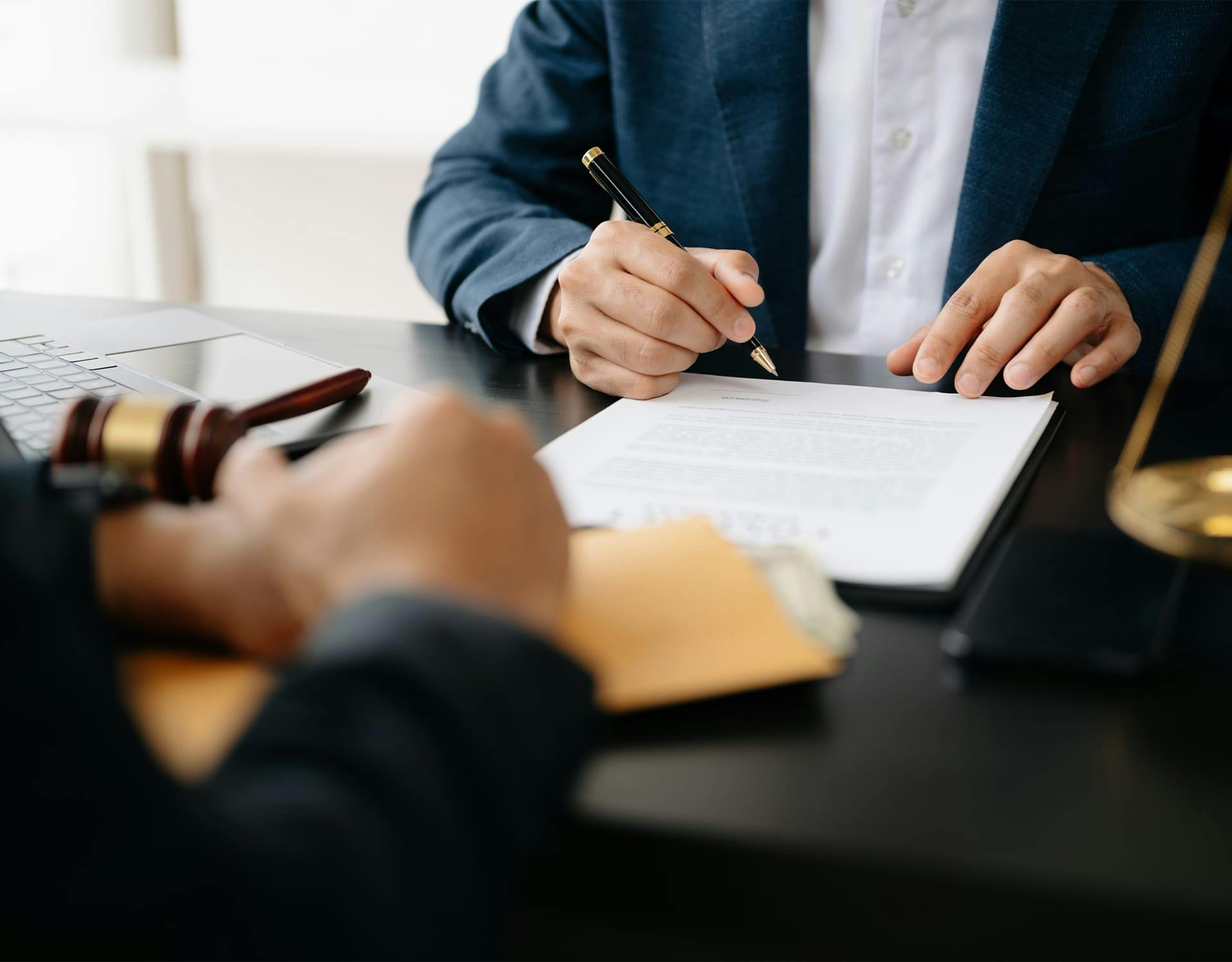 two people signing a document