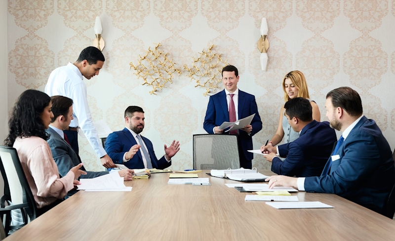 group of people in professional attire having meeting