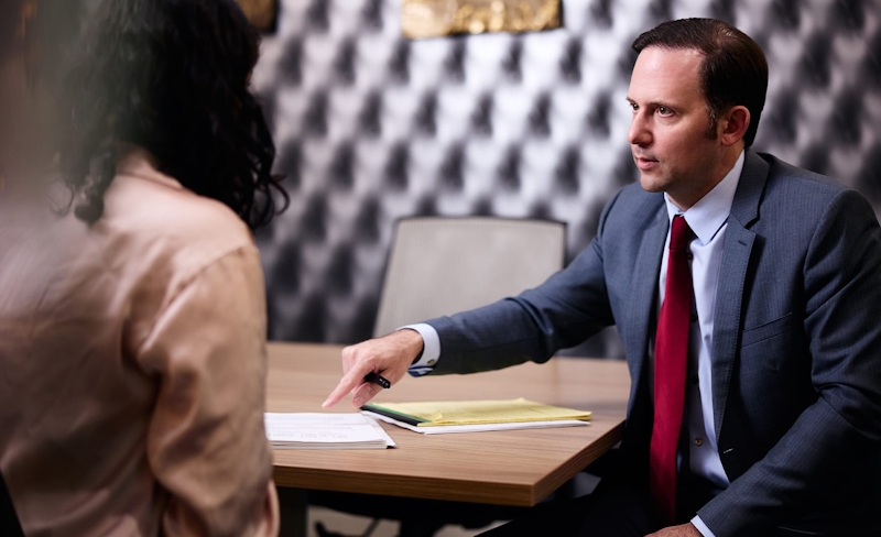man in suit sitting at meeting table