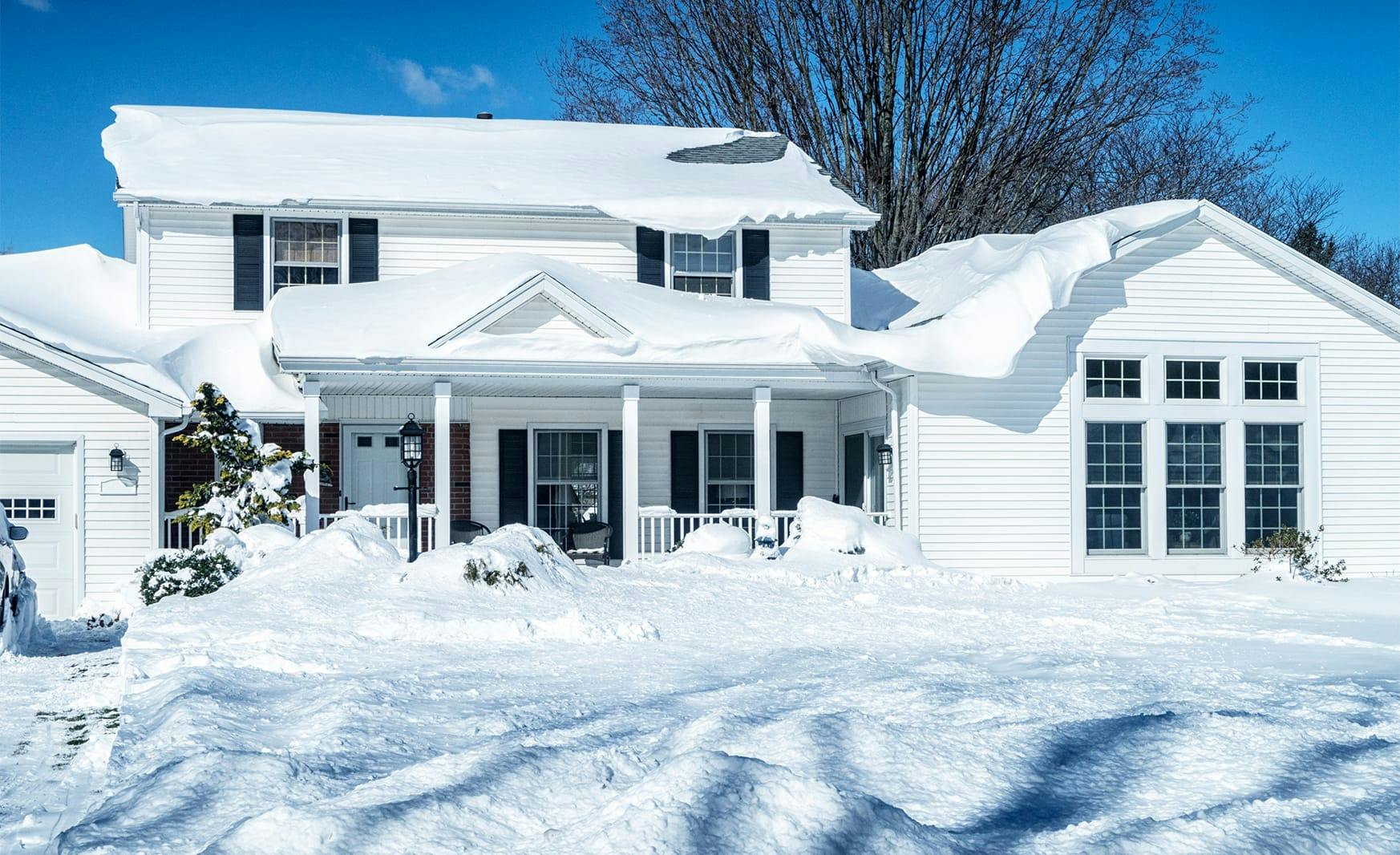 house piled with snow