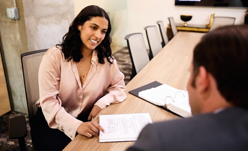 two people at a table looking at a document