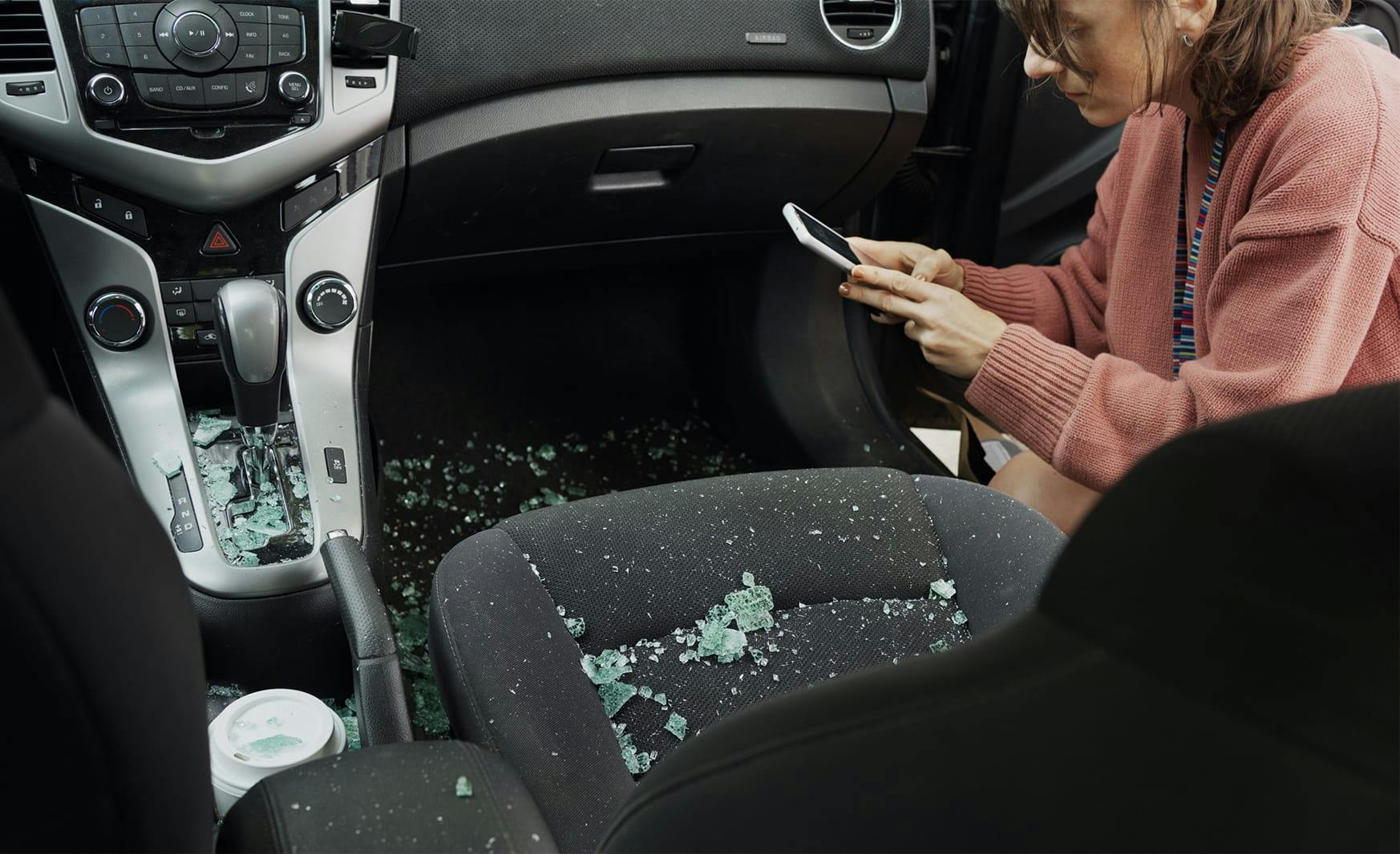 woman taking pictures of car damage