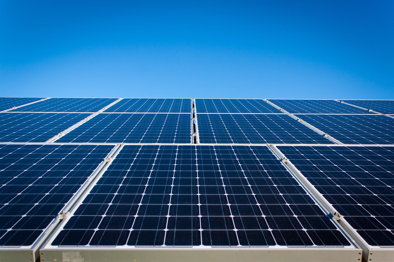 Rows of solar panels under a clear blue sky