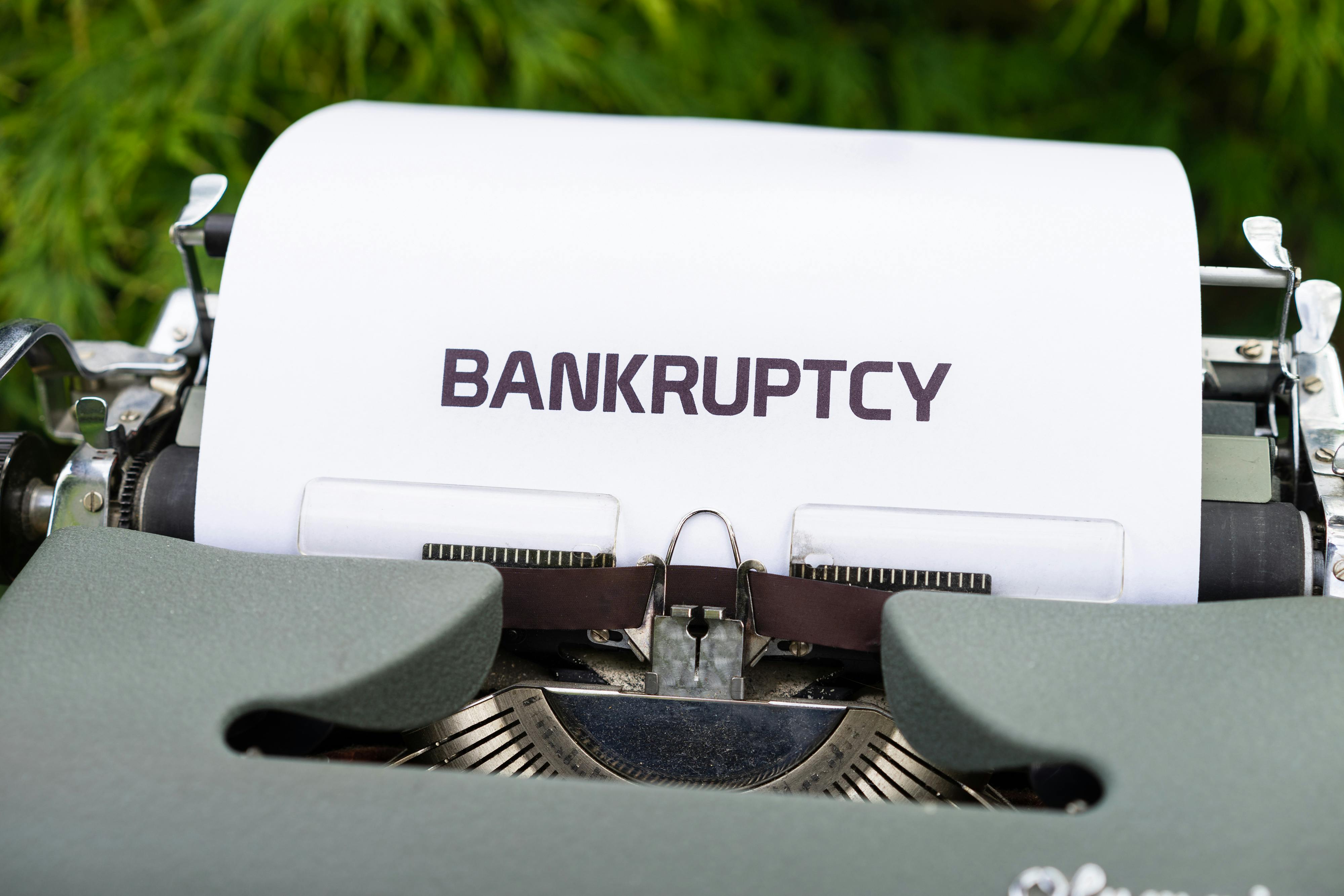 Typewriter with a sheet of paper that says 'BANKRUPTCY' in bold letters.