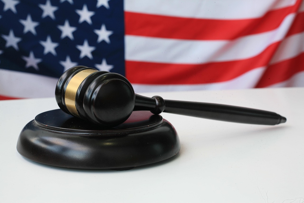 Judge’s gavel with American flag in the background