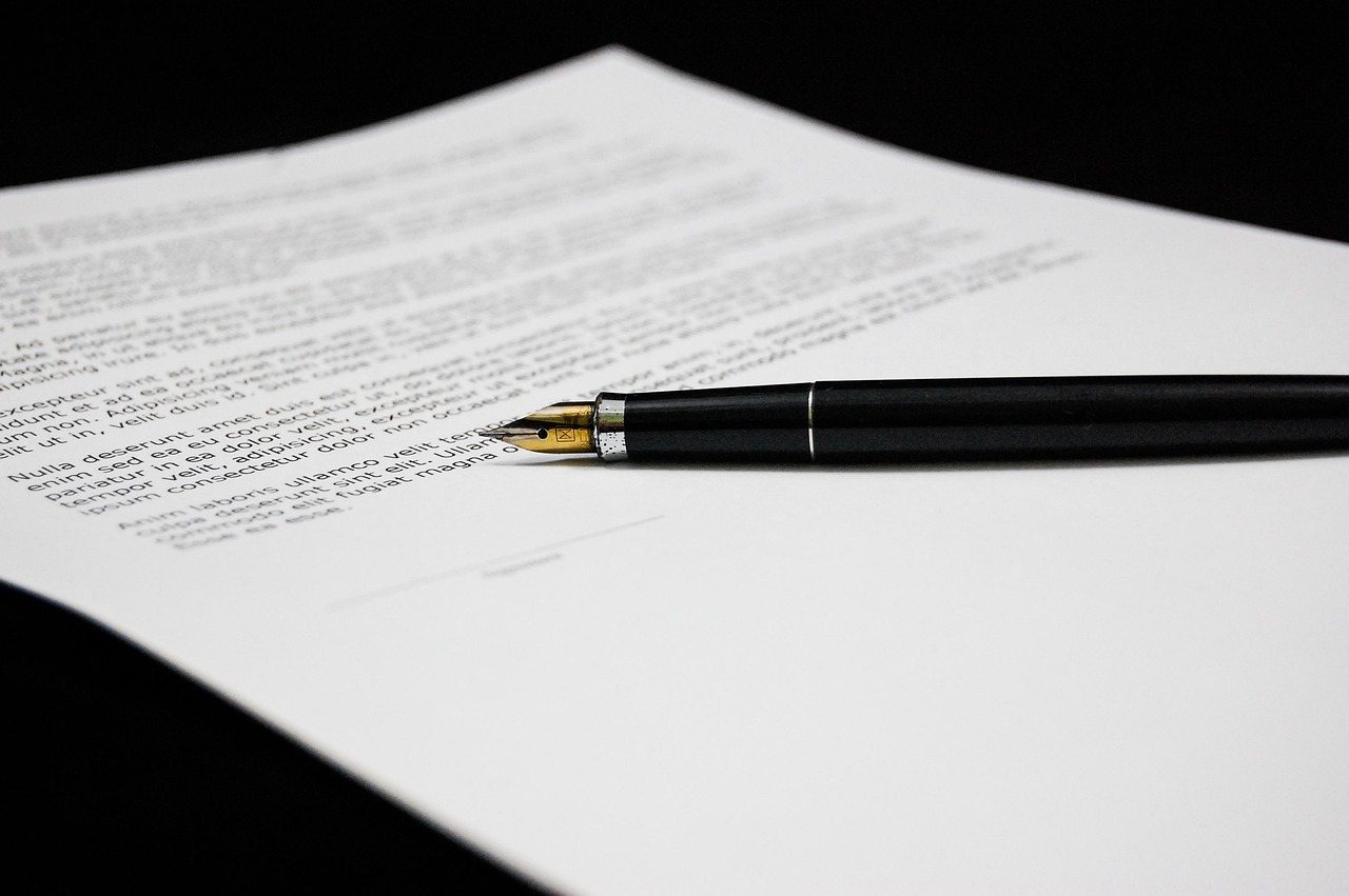 A black pen resting on a printed document