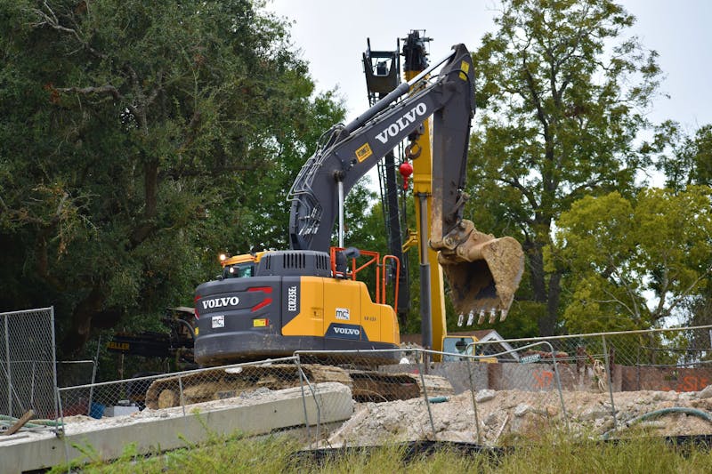 Construction site in Texas with excavator and heavy equipment during early-stage building project