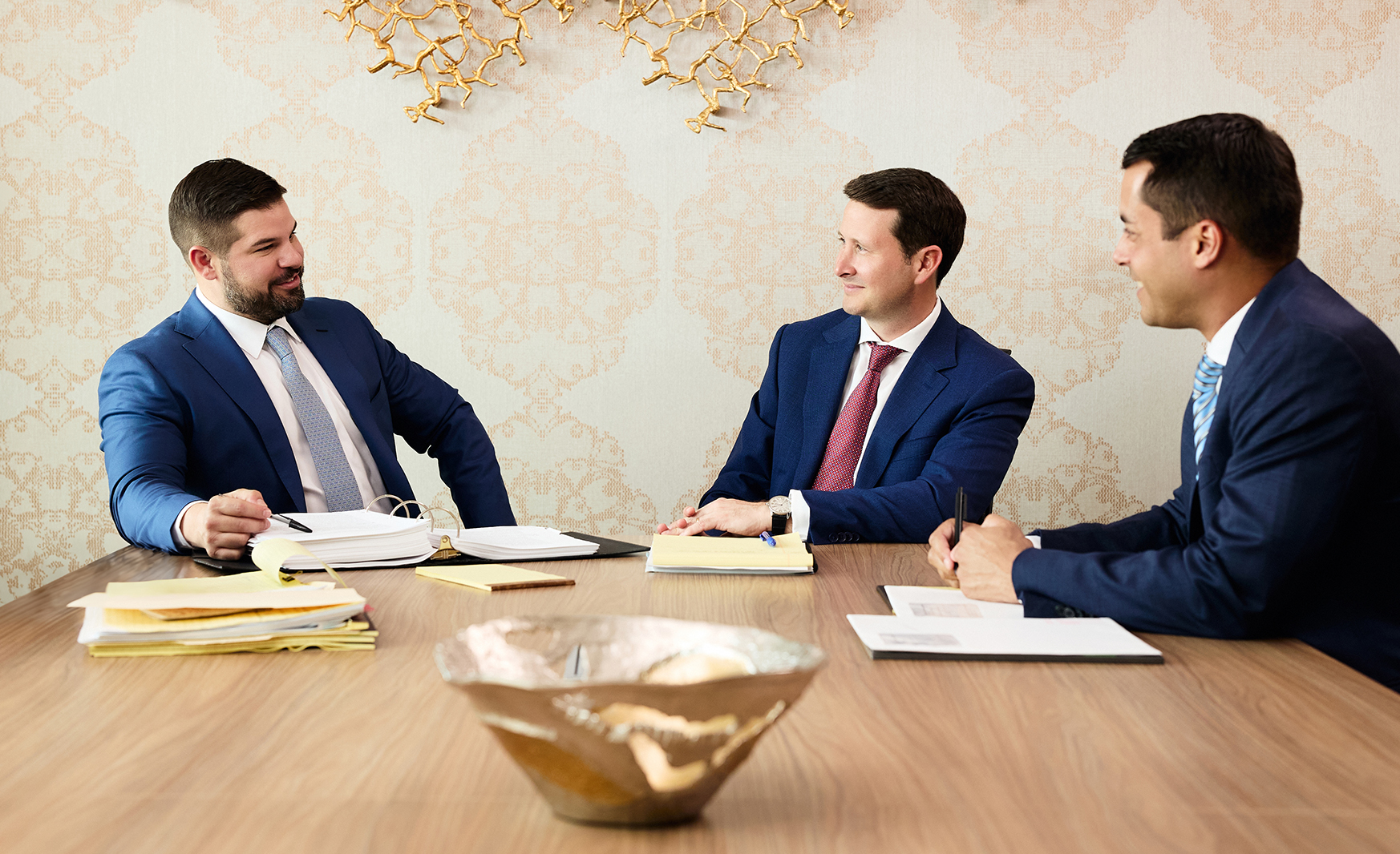 Attorneys discussing documents during a meeting at a conference table