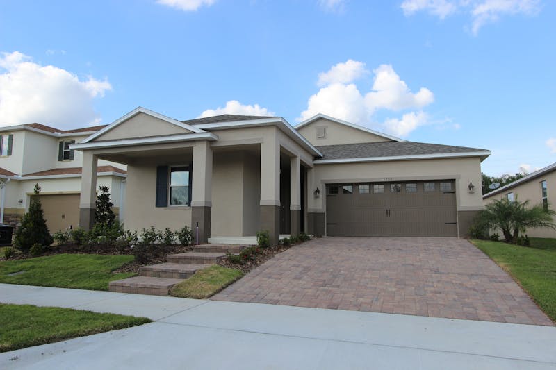 Florida residential home with asphalt shingle roof in suburban neighborhood