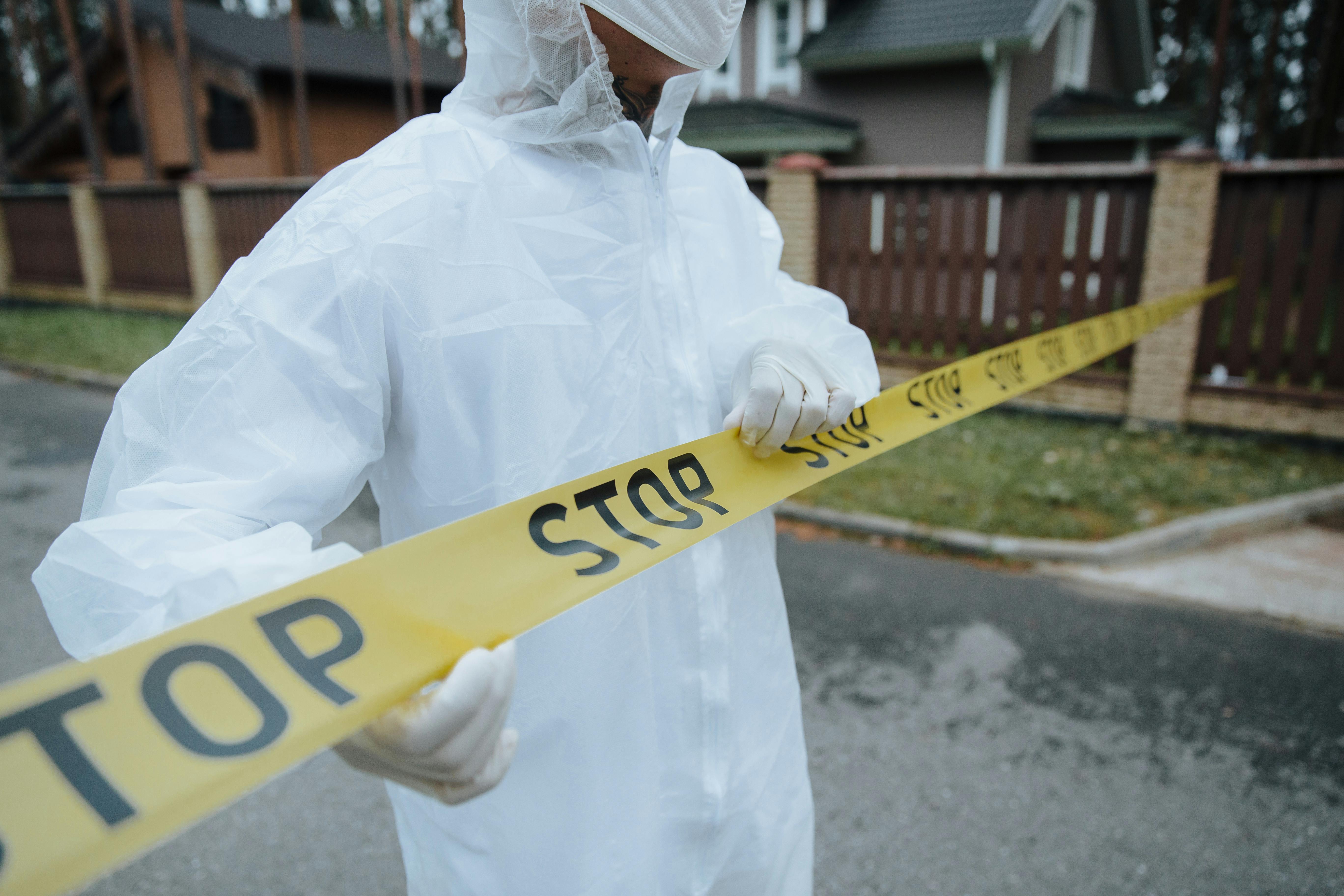 &bull; A fire investigator wearing protective gear while securing a fire scene after a possible lithium-ion battery fire.
