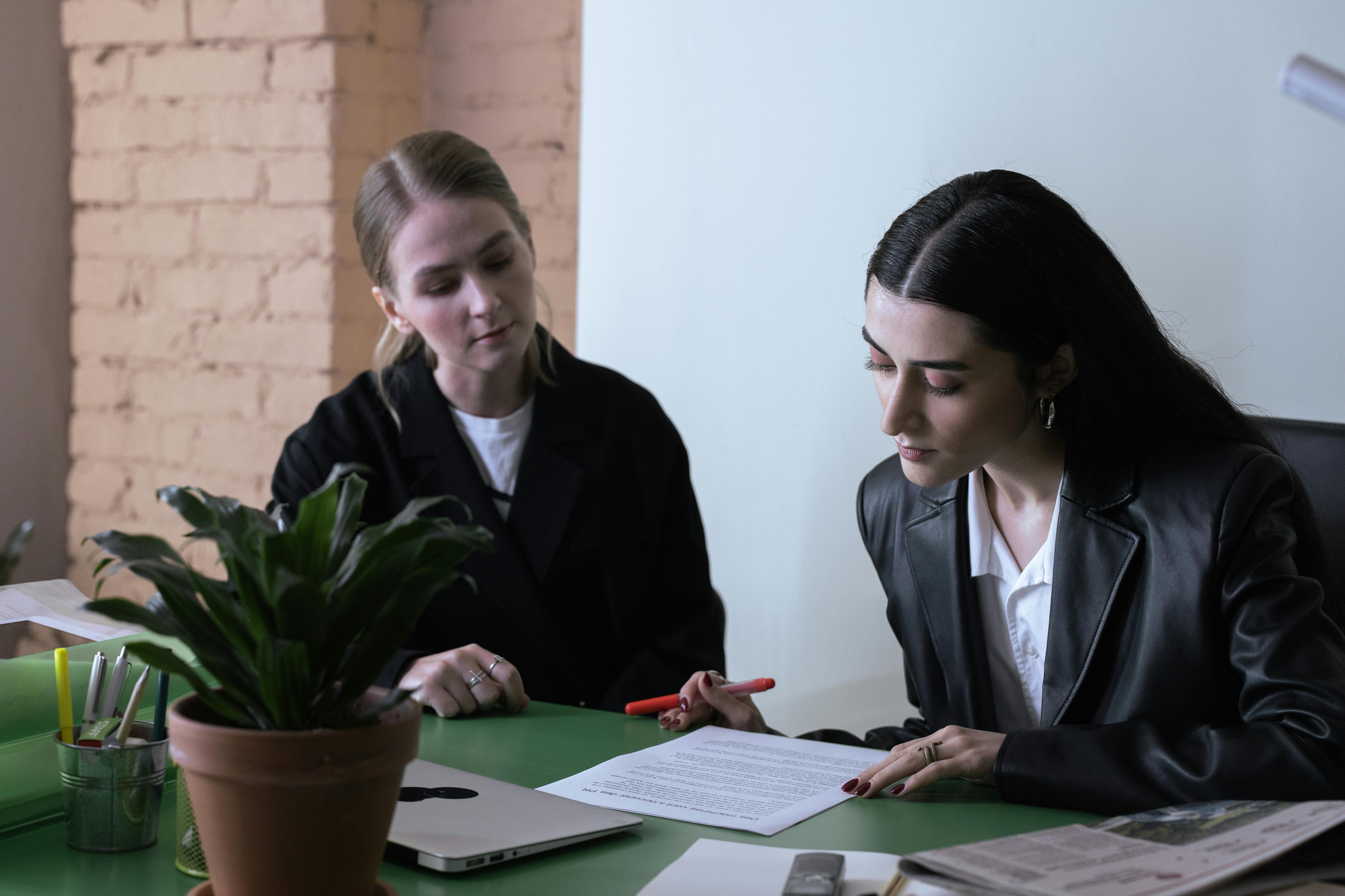 Business professionals reviewing paperwork during a solar-related legal consultation in an office setting.