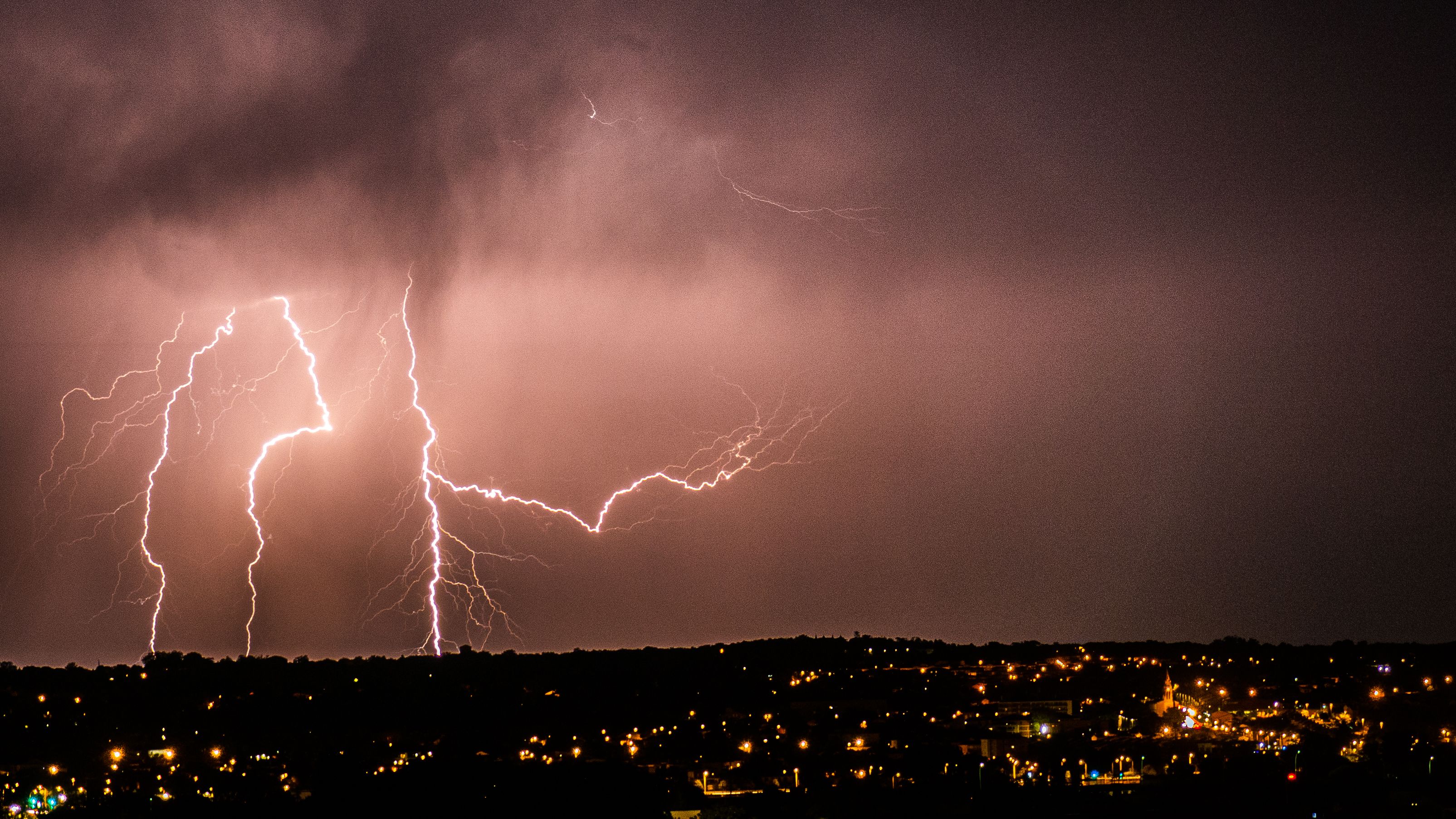 Lightning strikes during a severe thunderstorm, bringing heavy rain, damaging winds, and hail to a community.