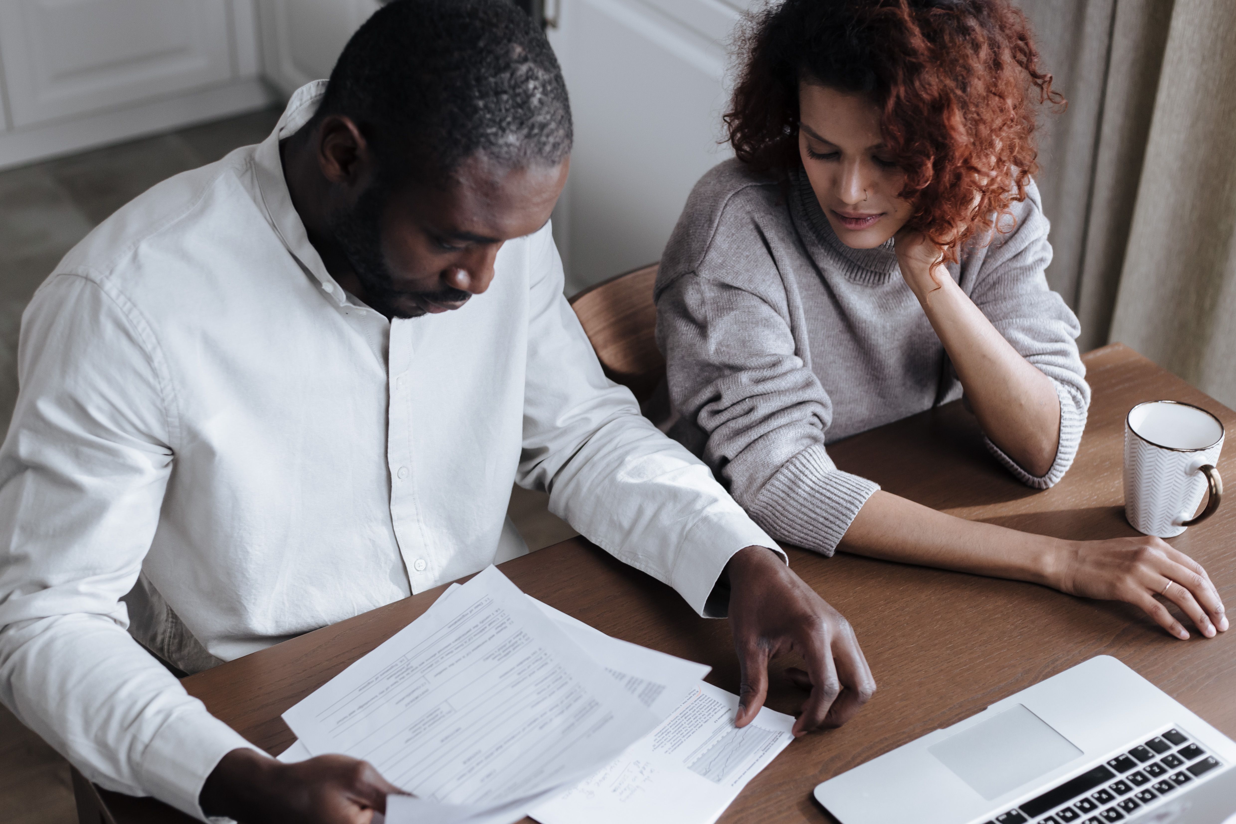 Florida homeowner reviewing a high homeowners insurance premium bill and household expenses.