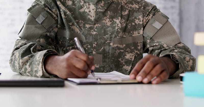 military soldier signing papers