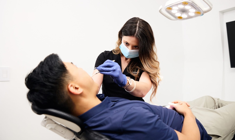 nurse inspecting patient's teeth