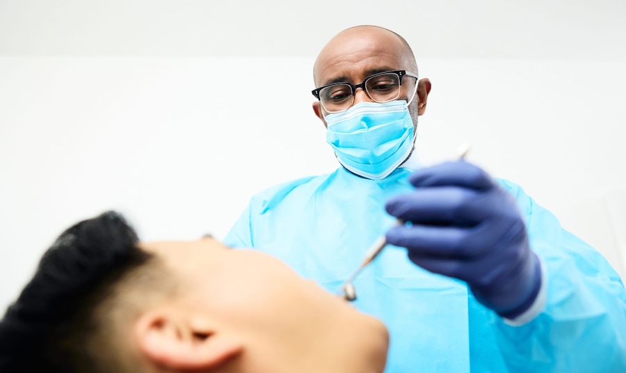 dr sinada looking into patients mouth