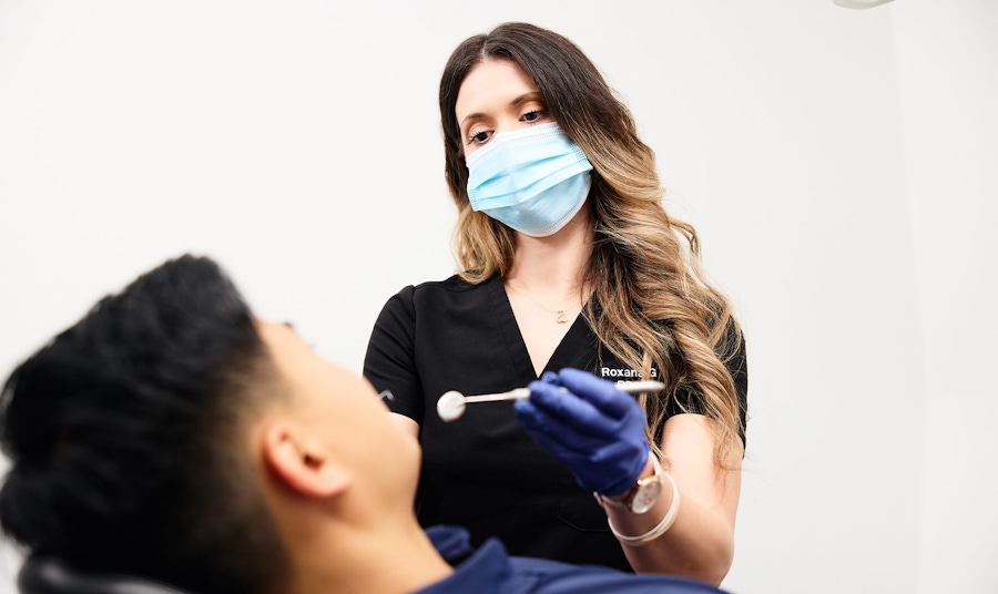 nurse checking patients teeth