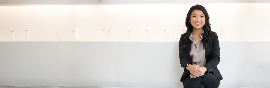 Dr. Lucy Dang sitting and smiling