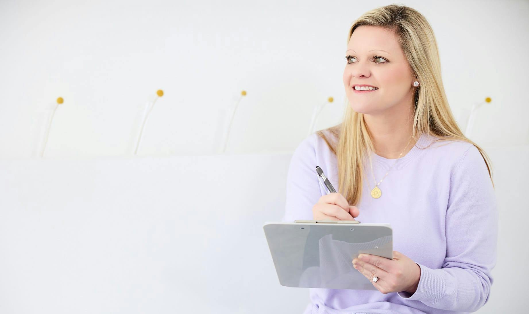 patient filling out forms on clipboard