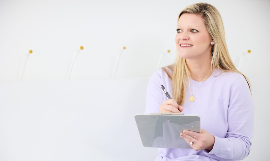 patient filling out forms on clipboard