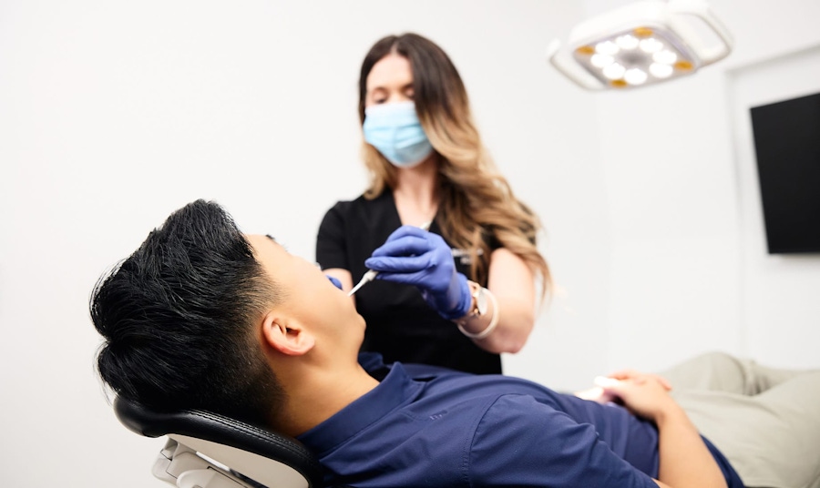 Dental assistant with a teeth whitening patient at Sinada Dental