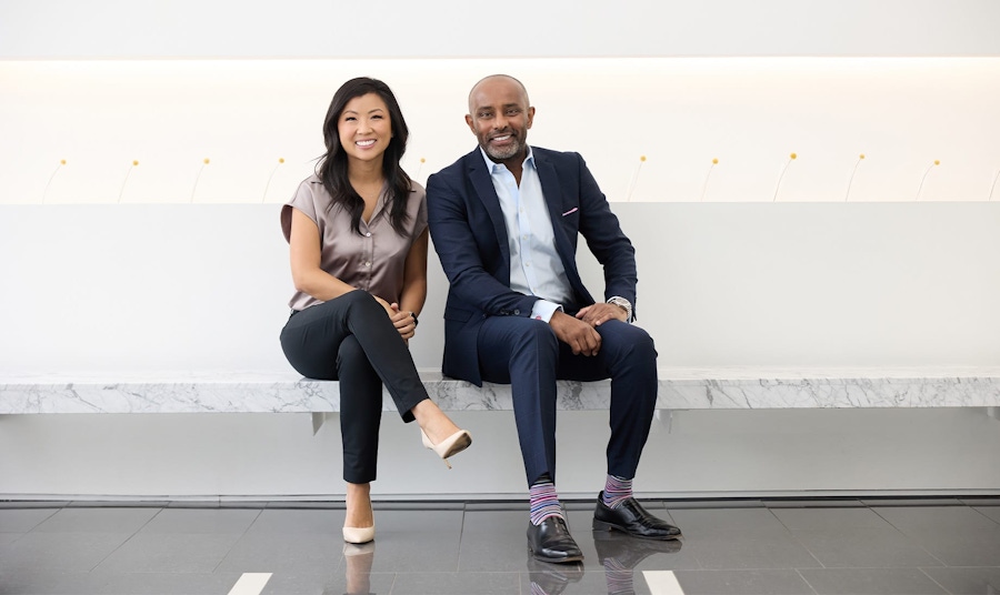 both doctors sitting and smiling on bench