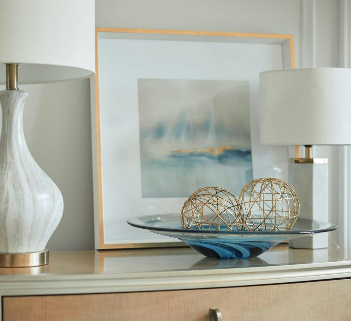 a painting, lamps, and spherical art