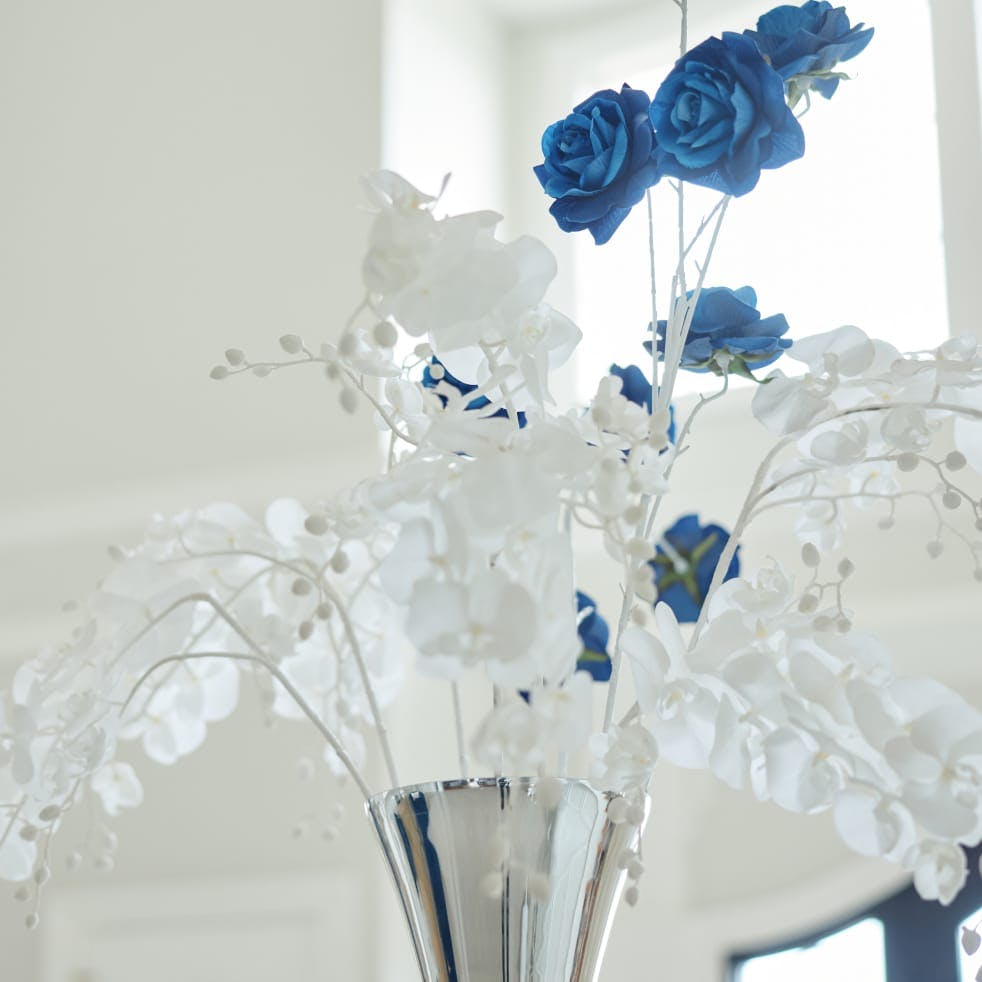 A vase of blue flowers