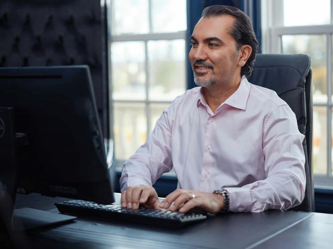 Dr. Aydin typing on a computer