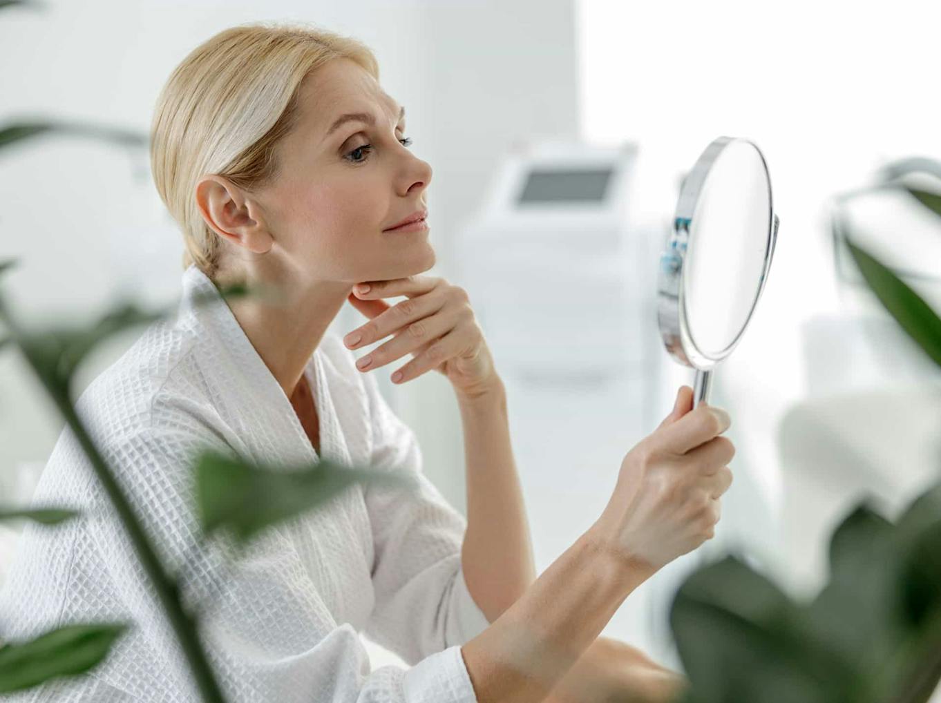Woman looking into mirror
