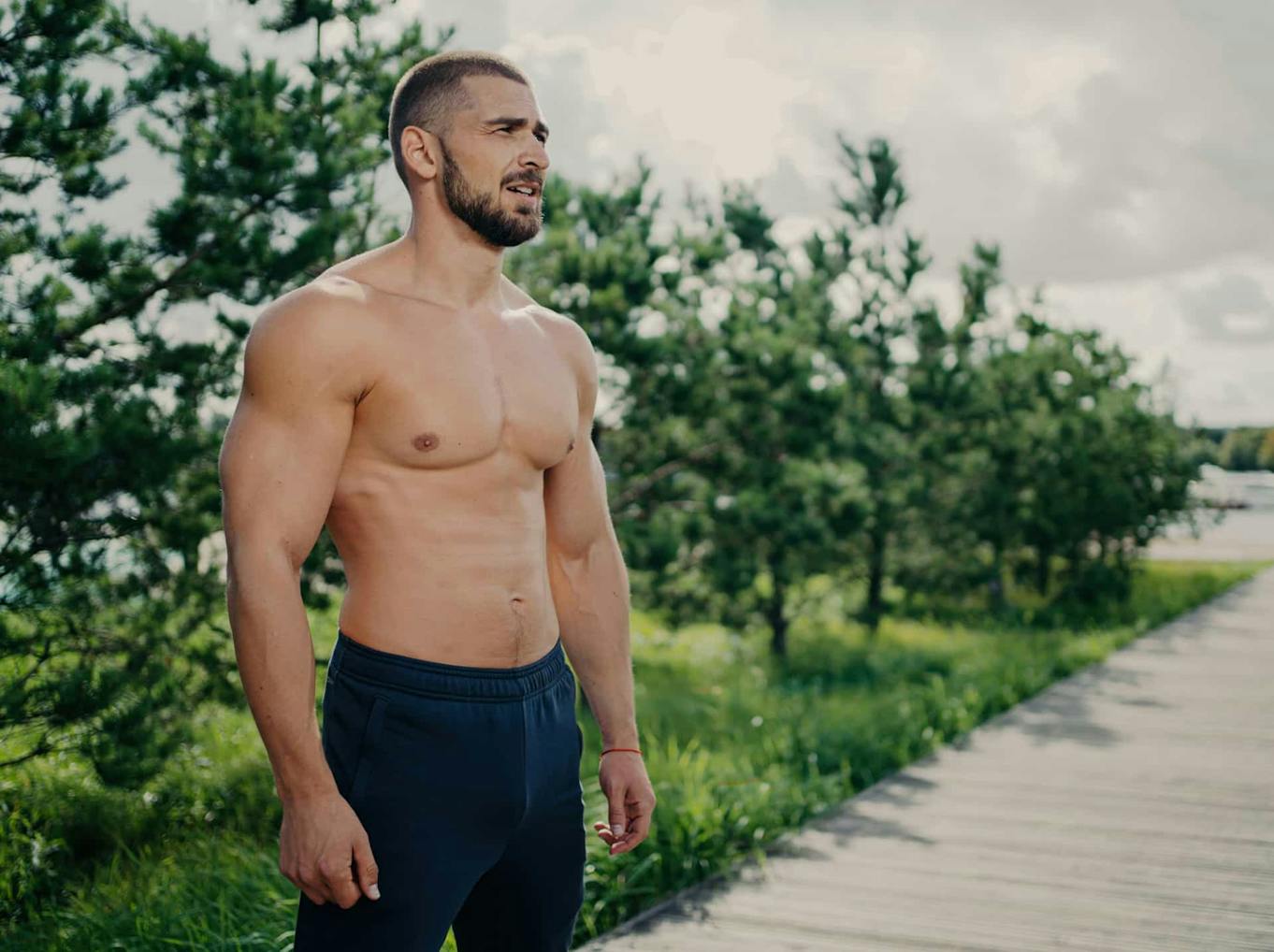 Shirtless man posing outdoors