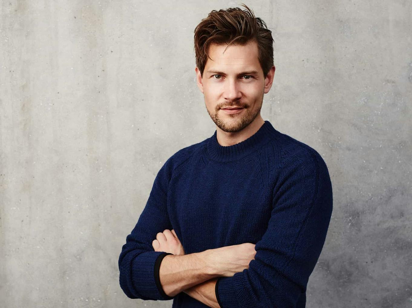 Man in a log sleeve shirt posing