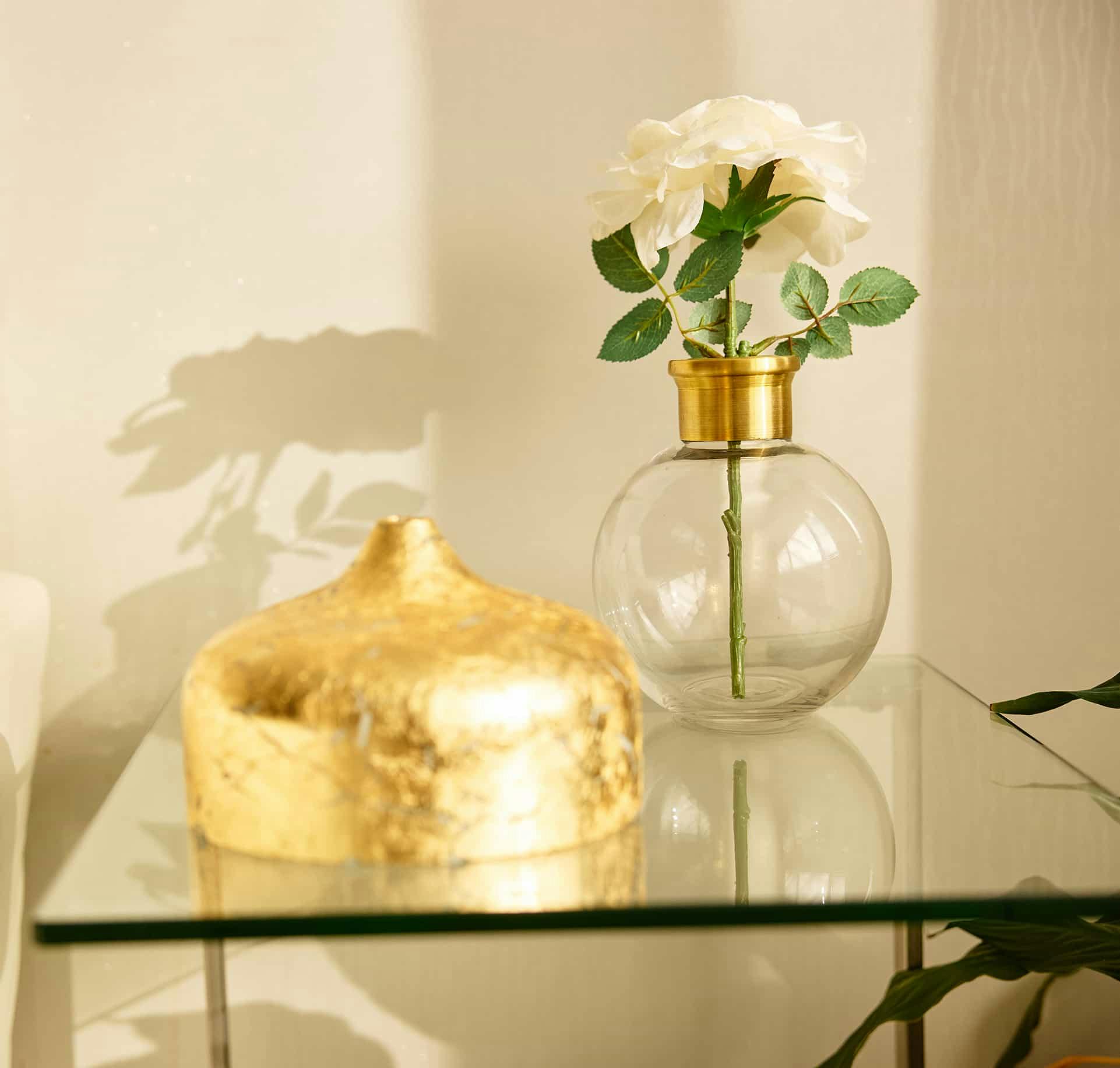 Flower vase on a glass table