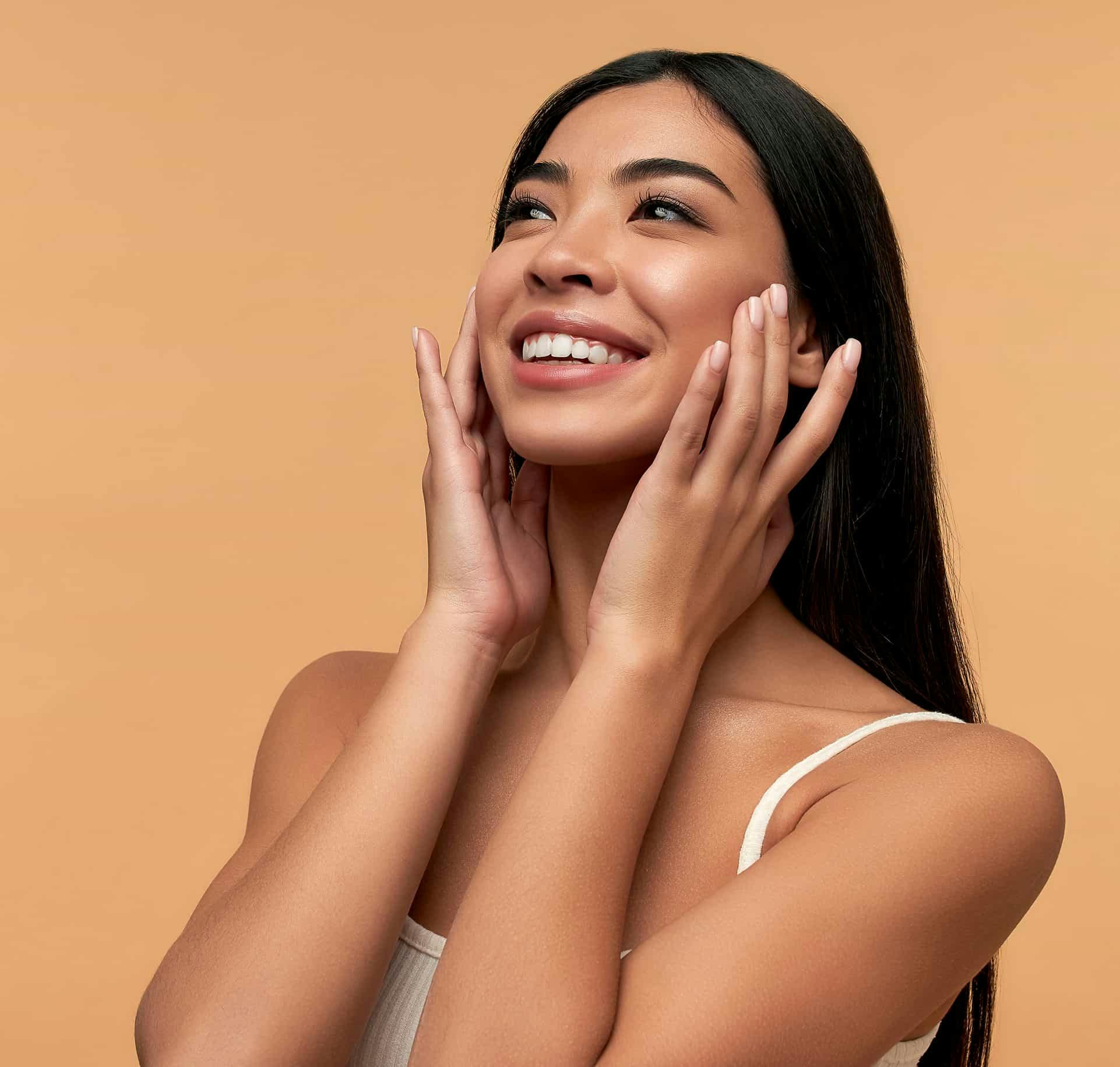 Woman touching face and smiling