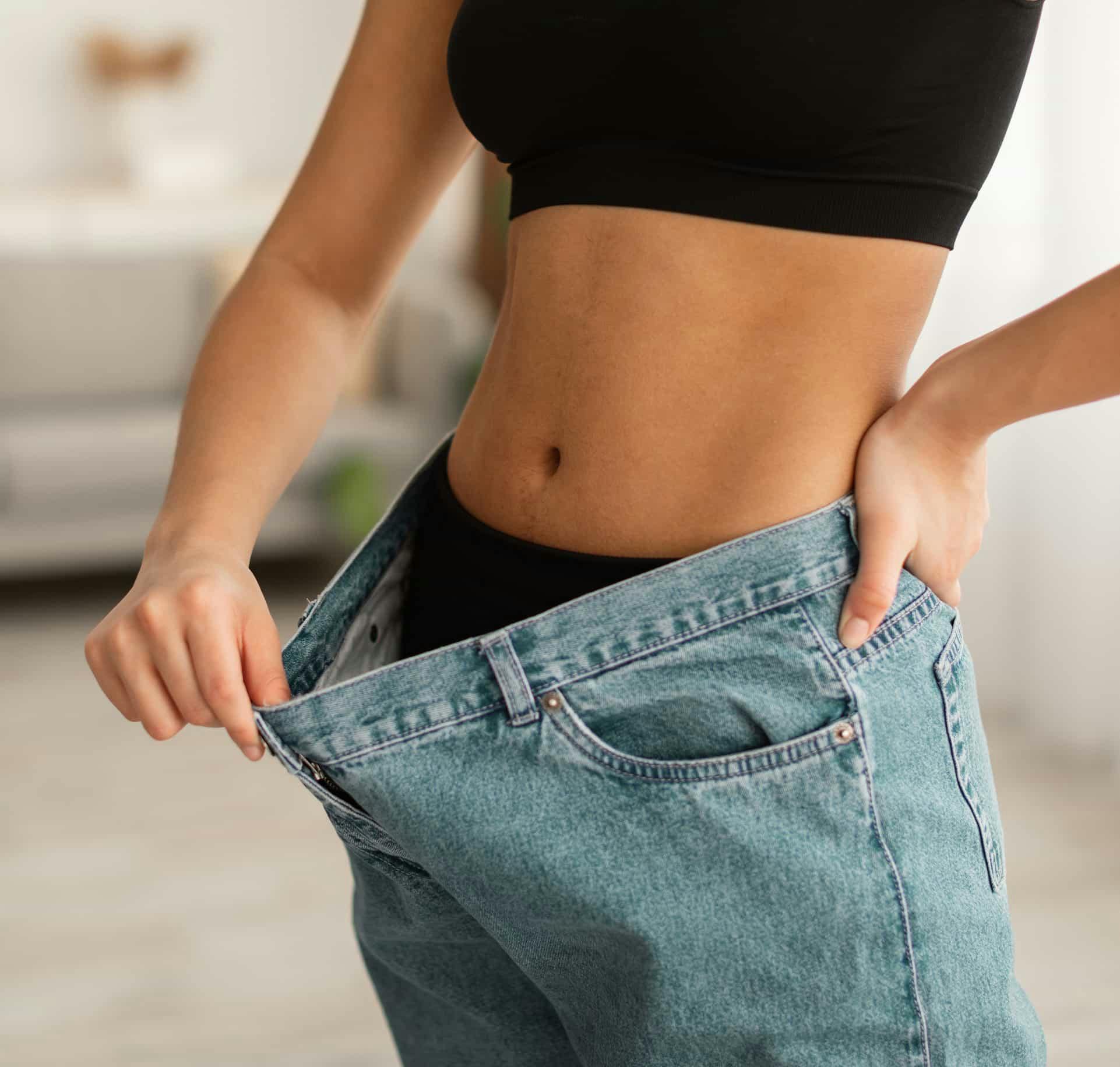 Woman pulling slack of pants
