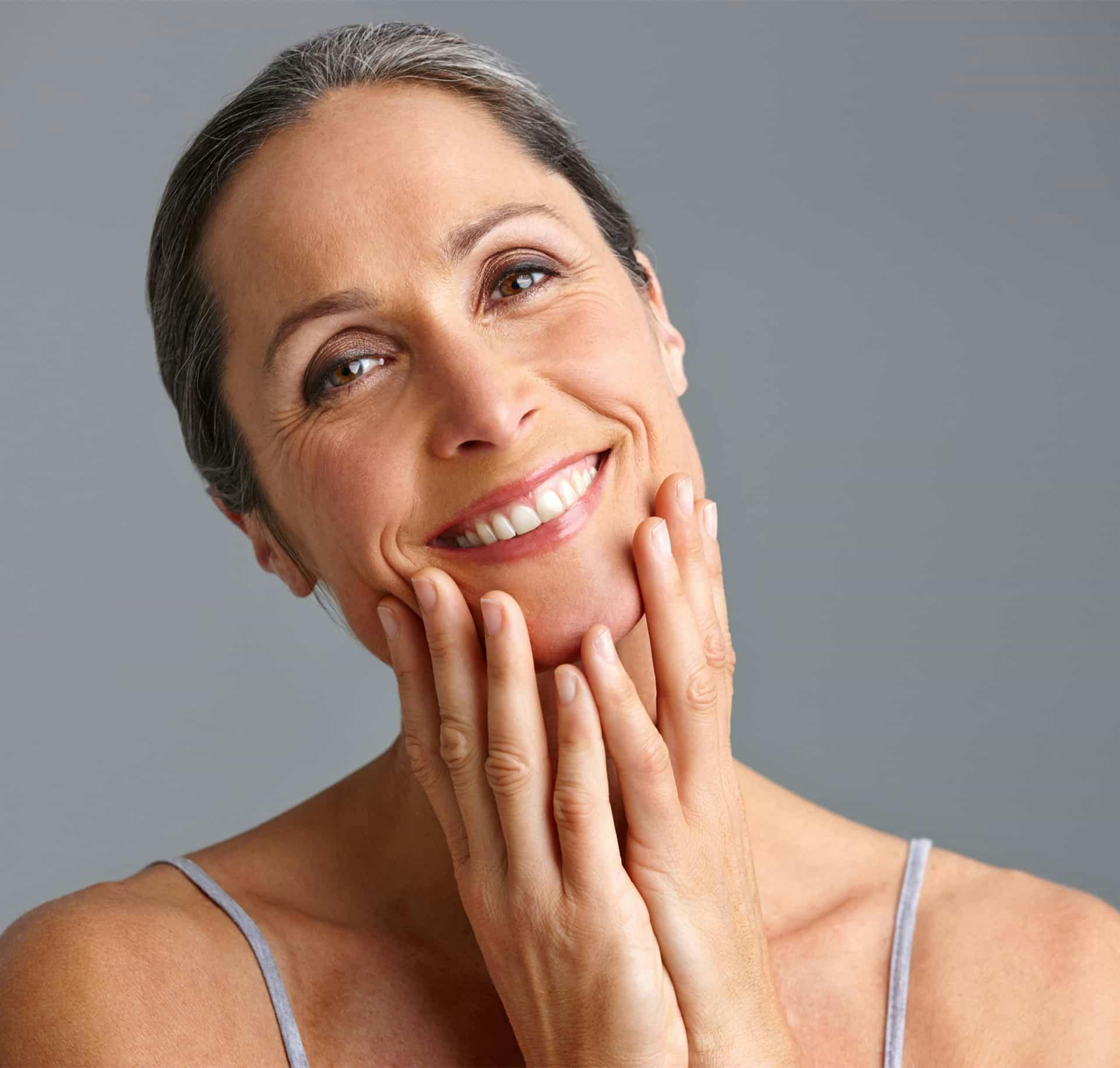 Woman touching face smiling