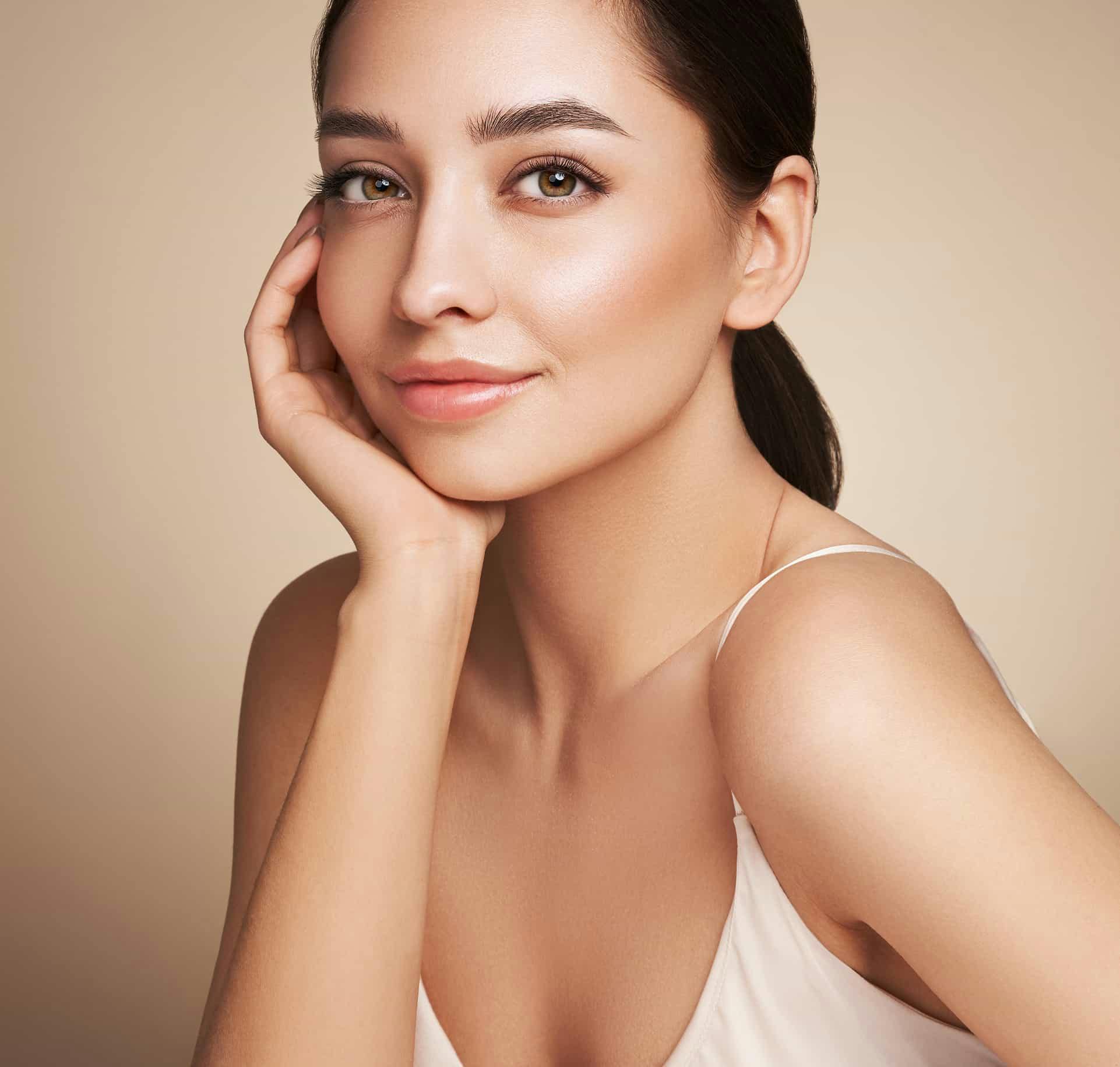 Woman smiling with chin resting on hand