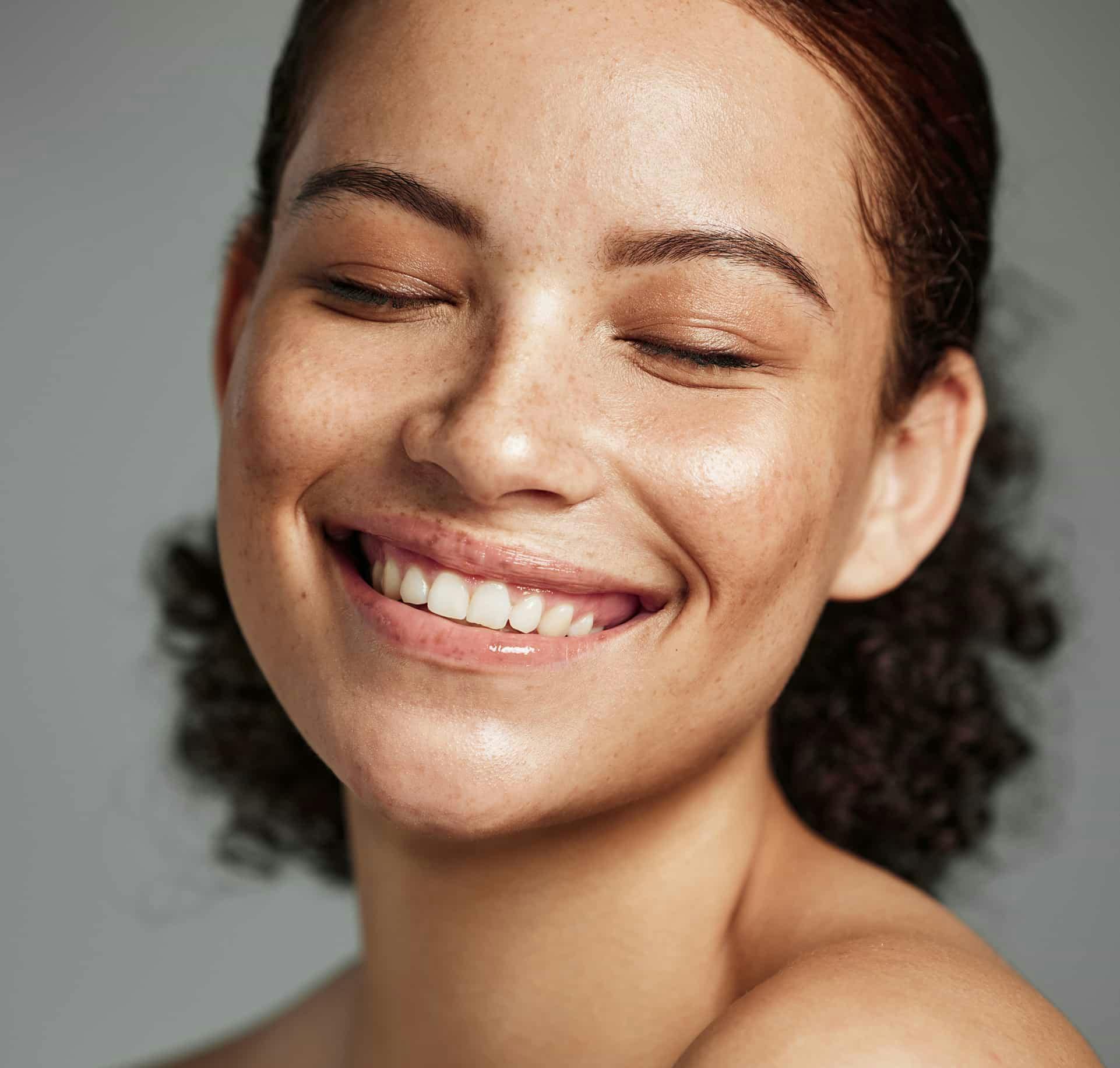 Woman smiling with eyes closed